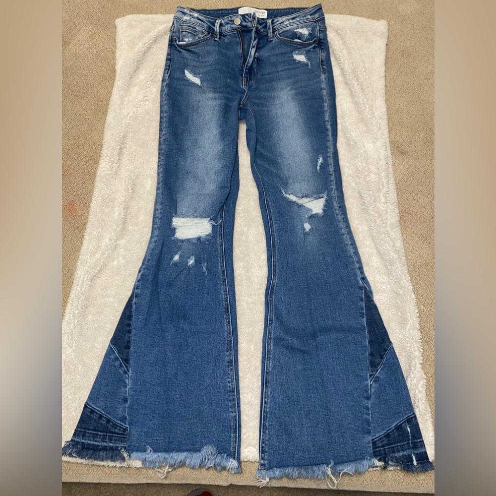 Medium wash. Distressed flare jeans